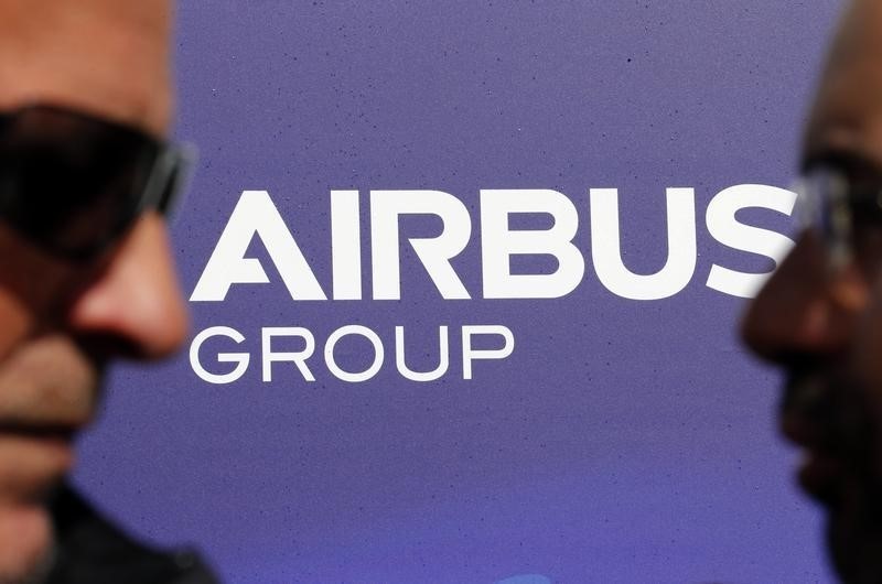 Visitors walk past the logo of Airbus Group during the e-Aircraft Day at the Bordeaux Merignac airport