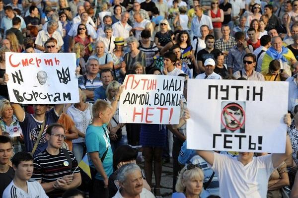 馬里烏波爾(Mariupol)：烏民眾遊行對抗議俄國軍事行動，舉牌寫著「普京滾回去」、「普京快回家，這沒伏特加」等標語 (圖:AFP)